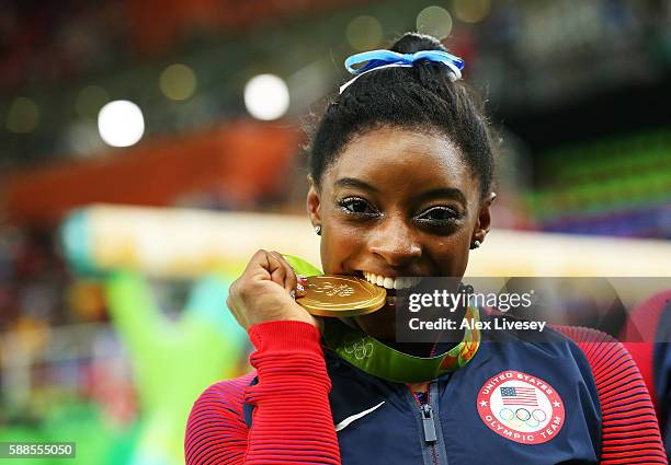 Gold medalist Simone Biles of the United States poses for photographs after the medal ceremony for the Women's Individual All Around on Day 6 of the...