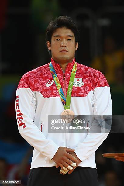 Bronze medalist, Ryunosuke Haga of Japan celebrates on the podium after the men's -100kg bronze medal judo contest against Artem Bloshenko of Ukraine...