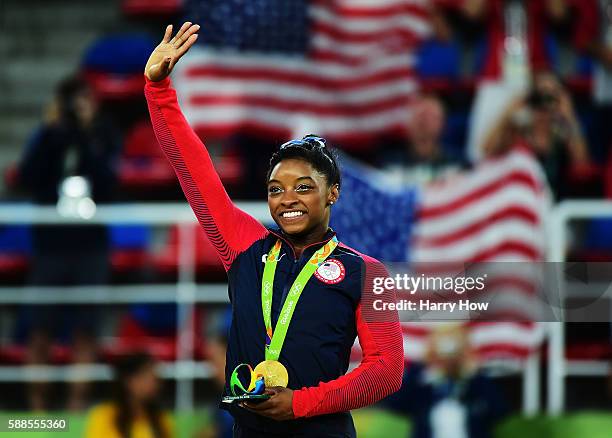 Gold medalist Simone Biles of the United States celebrates on the podium at the medal ceremony for the Women's Individual All Around on Day 6 of the...