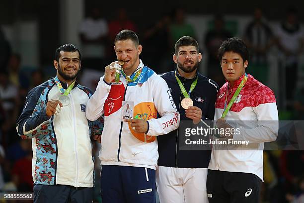 Silver medalist Elmar Gasimov of Azerbaijan, gold medalist Lukas Krpalek of the Czech Republic and bronze medalists Cyrille Maret of France and...