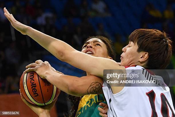 Japan's power forward Ramu Tokashiki defends against Australia's centre Elizabeth Cambage during a Women's round Group A basketball match between...