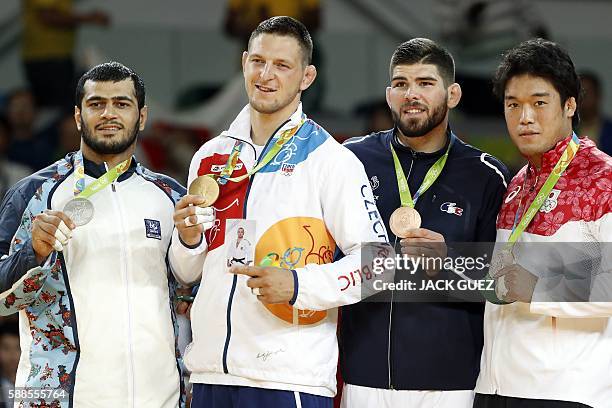 Azerbaijan's Elmar Gasimov , Czech Republic's Lukas Krpalek , France's Cyrille Maret and Japan's Ryunosuke Haga celebrate on the podium of the men's...