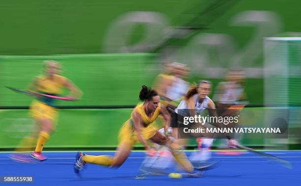 Australia's Madonna Blyth hits the ball during the women's field hockey Australia vs Argentina match of the Rio 2016 Olympics Games at the Olympic...