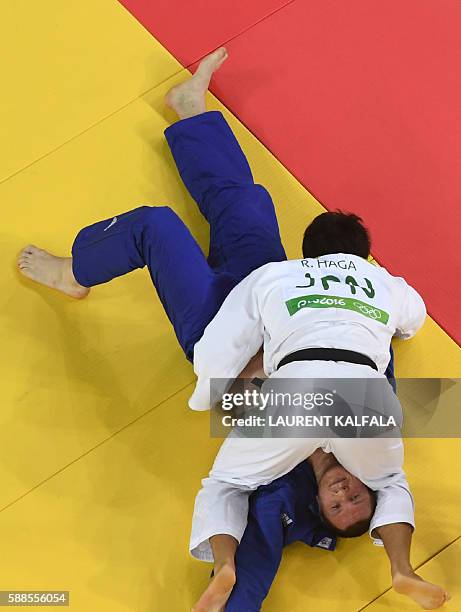 Japan's Ryunosuke Haga competes with Ukraine's Artem Bloshenko during their men's -100kg judo contest bronze medal B match of the Rio 2016 Olympic...