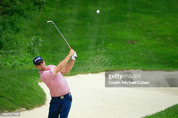 Hunter Mahan plays a shot from a bunker on the ninth hole during the first round of the John Deere Classic at TPC Deere Run on August 11, 2016 in...