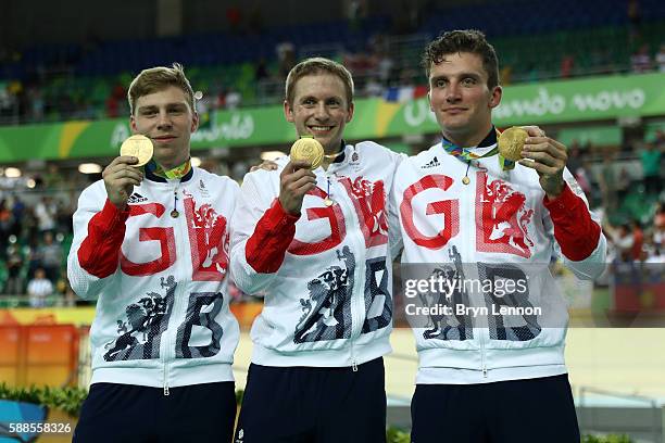 Philip Hindes, Jason Kenny and Callum Skinner of Great Britain celebrate after winning gold and getting an Olympic record in the Men's Team Sprint...