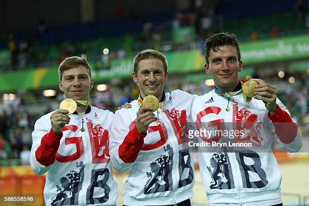 Gold medalists Philip Hindes, Jason Kenny and Callum Skinner of Great Britain celebrate on the podium after winning the Men's Team Sprint Track...