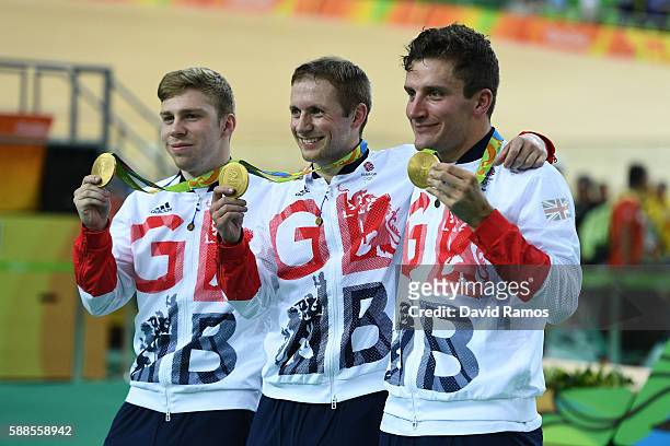 Gold medalists Philip Hindes, Jason Kenny and Callum Skinner of Great Britain celebrate after the Men's Team Sprint Track Cycling Finals on Day 6 of...