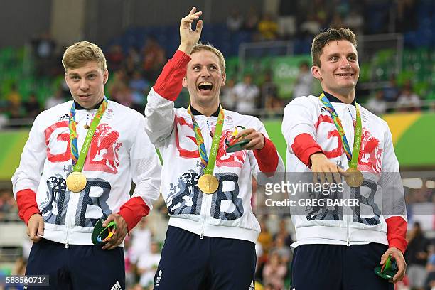 Gold medalists Britain's Philip Hindes, Jason Kenny and Callum Skinner pose on the podium with their medals after winning the men's Team Sprint track...