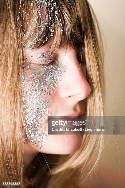 blonde woman with glitter on her face - glitter make up stock pictures, royalty-free photos & images