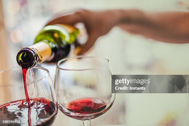 pouring red wine in glasses - empty wine glass stock pictures, royalty-free photos & images