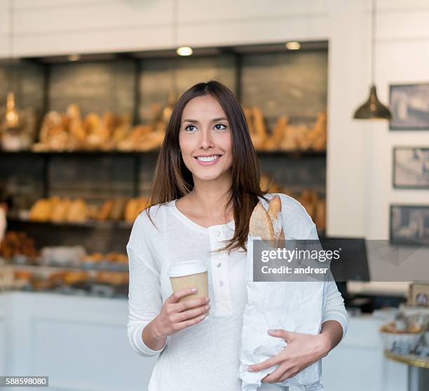 woman buying bread at the bakery - supermarket bread stock pictures, royalty-free photos & images