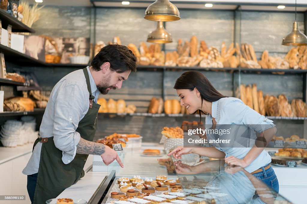 Woman buying cakes at a pastry shop
