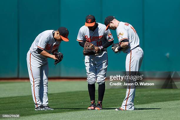 Hyun Soo Kim of the Baltimore Orioles, Adam Jones and Nolan Reimold celebrate after the game against the Oakland Athletics at the Oakland Coliseum on...
