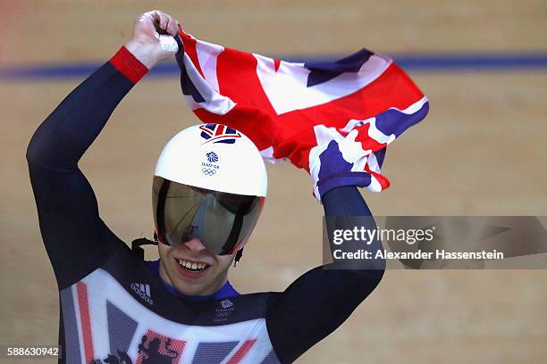 Philip Hindes of Great Britain celebrates after wining gold in the Men's Team Sprint Track Cycling Finals on Day 6 of the 2016 Rio Olympics at Rio...