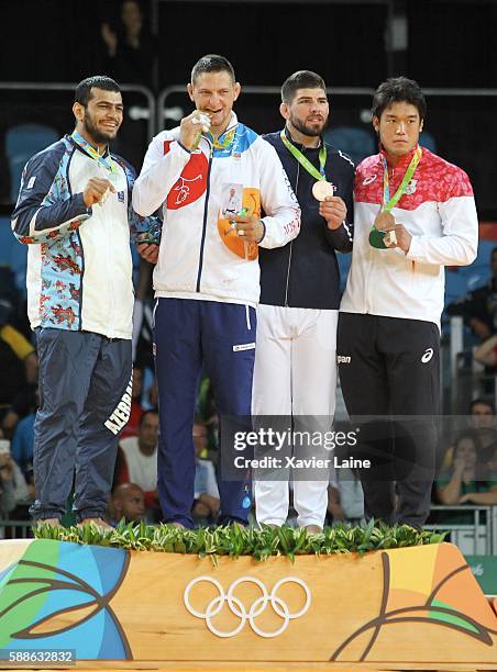 Lukas Krpalek of Czech Republic celebrate his gold medal with Elmar Gasimov of Azerbadjan and Cyrille Maret of France after the final Judo men's...