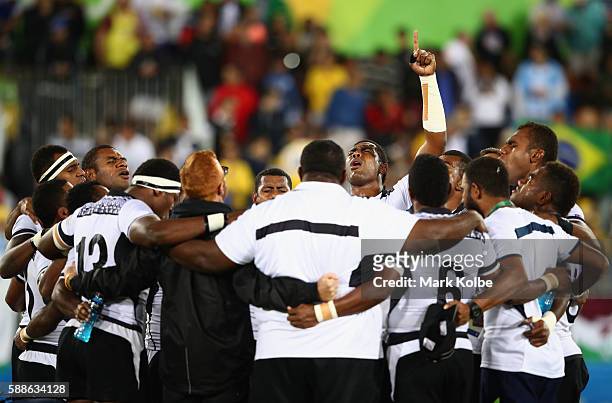 Fiji players and staff huddle as they win gold after the Men's Rugby Sevens Gold medal final match between Fiji and Great Britain on Day 6 of the Rio...