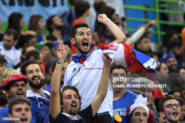 French fans cheer their team during the men's preliminaries Group A handball match France vs Argentina for the Rio 2016 Olympics Games at the Future...