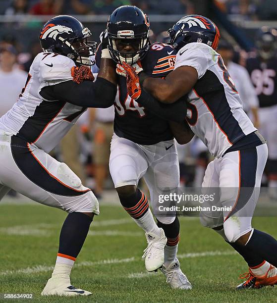 Leonard Floyd of the Chicago Bears rushes against Darrion Weems and Virgil Green of the Denver Broncos at Soldier Field on August 11, 2016 in...