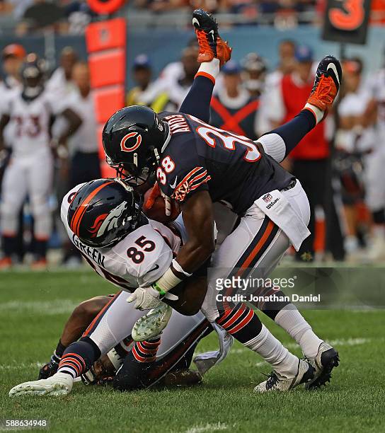 Virgil Green of the Denver Broncos is dropped by Adrian Amos and Demontre Hurst of the Chicago Bears at Soldier Field on August 11, 2016 in Chicago,...