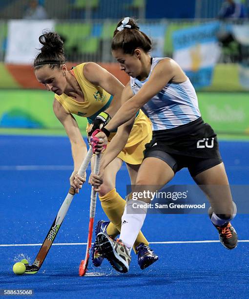 Madonna Blyth of Australia attempts to run past Lucina Von der Heyde of Argentina during a Women's Preliminary Pool B match at the Olympic Hockey...