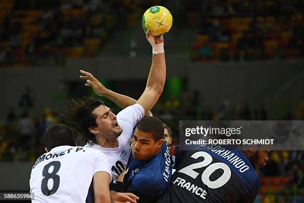 Argentina's right back Federico Vieyra vies with France's centre back Daniel Narcisse and France's pivot Cedric Sorhaindo during the men's...