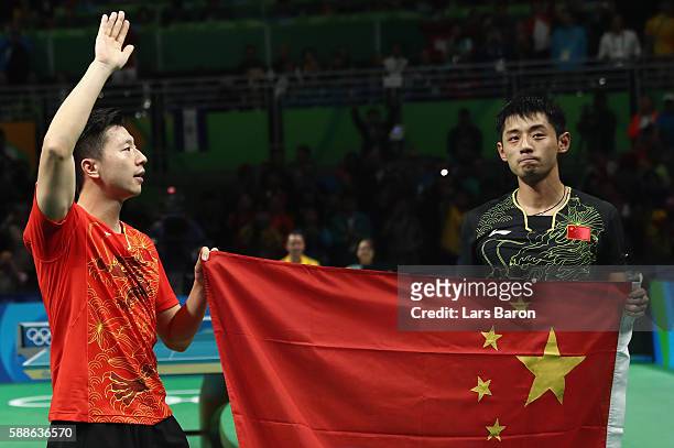 Ma Long and Zhang Jike of China are seen after the Mens Table Tennis Gold Medal match between Ma Long of China and Zhang Jike of China at Rio Centro...