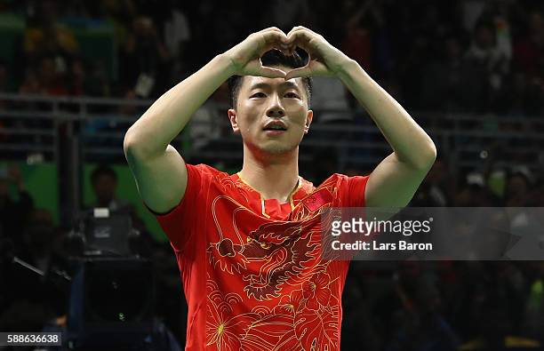 Long of China celebrates after winning the Mens Table Tennis Gold Medal match between Ma Long of China and Zhang Jike of China at Rio Centro on...