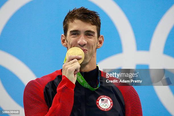 Gold medalist Michael Phelps of the United States celebrates on the podium during the medal ceremony for the Men's 200m Individual Medley Final on...