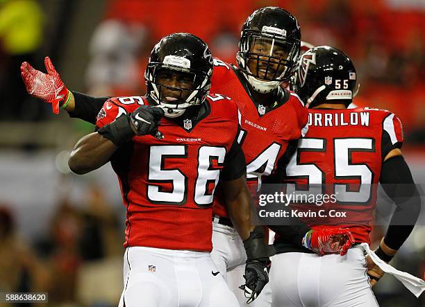 Sean Weatherspoon of the Atlanta Falcons reacts with Vic Beasley after a tackle against the Washington Redskins at Georgia Dome on August 11, 2016 in...