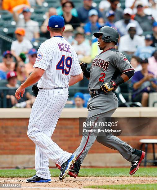 Jean Segura of the Arizona Diamondbacks scores in the sixth inning past Jonathon Niese of the New York Mets after a passed ball at Citi Field on...
