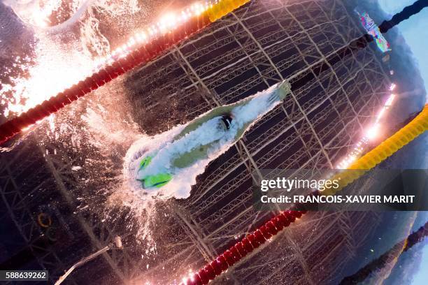 Underwater view shows USA's Tom Shields taking part in the Men's 100m Butterfly Semifinal during the swimming event at the Rio 2016 Olympic Games at...