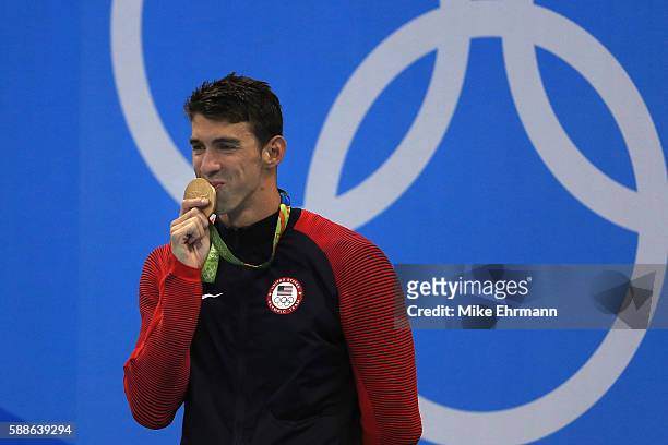 Gold medalist Michael Phelps of the United States poses on the podium during the medal ceremony for the Men's 200m Individual Medley Final on Day 6...