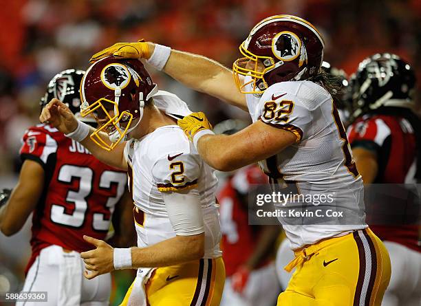 Logan Paulsen of the Washington Redskins congratulates Nate Sudfeld after he passed for a touchdown against the Atlanta Falcons at Georgia Dome on...