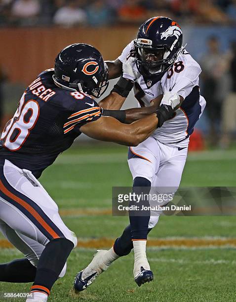 Antonio Glover of the Denver Broncos tries to hold back Rob Housler of the Chicago Bears at Soldier Field on August 11, 2016 in Chicago, Illinois....