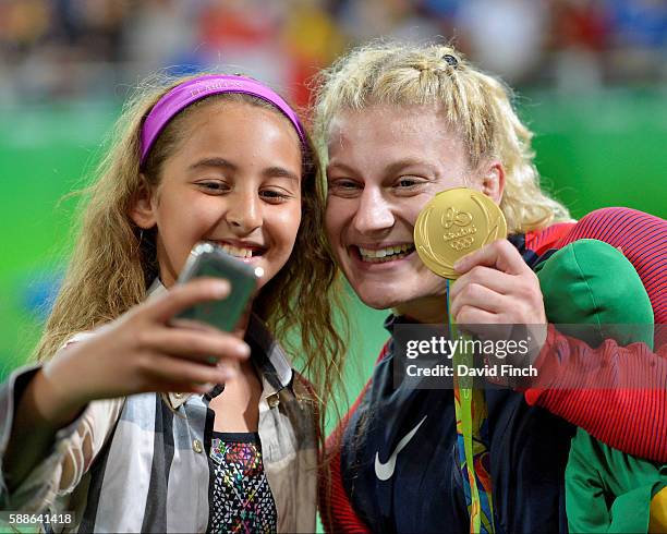 Under 78kg judo gold medallist, Kayla Harrison of the USA, poses for a young fan's 'selfie' with her gold medal during day 6 at the 2016 Rio Olympics...