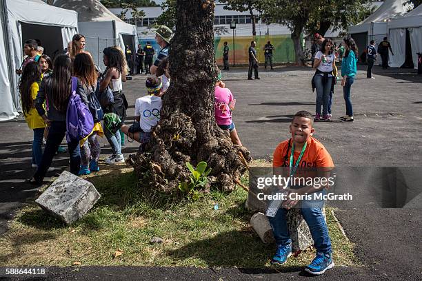 Diego, from the Cantagalo 'favela' community takes a break after passing through the security check point at the Olympic Rugby 7's venue on August...