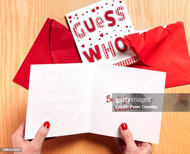 woman reading valentine card - valentine card fotografías e imágenes de stock