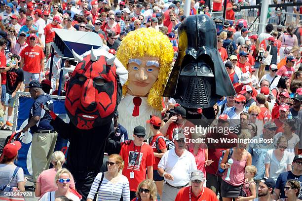 The Washington Nationals Racing Presidents dressed as Star Wars characters from left Darth Maul, Luke Skywalker and Darth Vader walk through the...