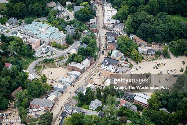 Workers asses damage along Main Street in Ellicott City, MD on Friday August 05, 2016. Ellicott City was ravaged by floodwaters Saturday night,...