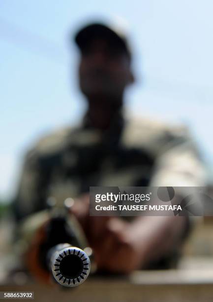 An Indian paramilitary trooper stands guard outside The Bakshi Stadium in Srinagar on August 12 the main venue for India's Independence day...