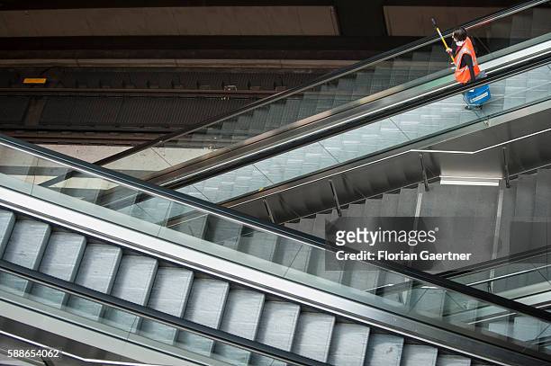 Cleaning person takes an escalator to go down at the main station on August 11, 2016 in Berlin, Germany.