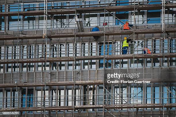 Workers are captured on a scaffolding on August 11, 2016 in Berlin, Germany.
