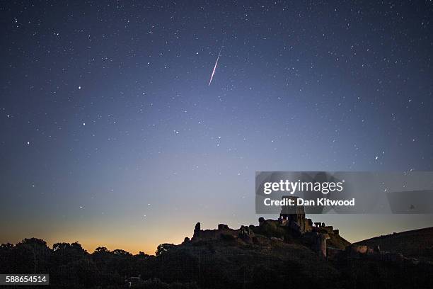 Perseid Meteor flashes across the night sky above Corfe Castle on August 12, 2016 in Corfe Castle, United Kingdom. The Perseids meteor shower occurs...