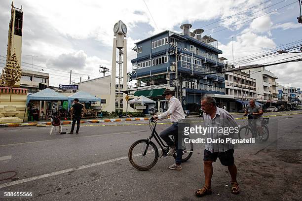 Tourists ride bicycles past the site of an explosion on Friday, August 12, 2016 in Hua Hin, Thailand. A series of coordinated blasts across Southern...