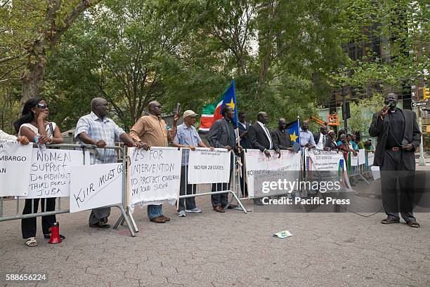 South Sudanese demonstrators hold signs while rallying in Dag Hammarskjold Plaza. On the same day that the United Nations Security Council held...