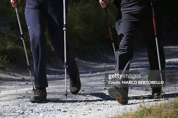 Picture shows the legs and feet of British Prime Minister Theresa May and her husband Philip in a forest at the start of a summer holiday in the Alps...