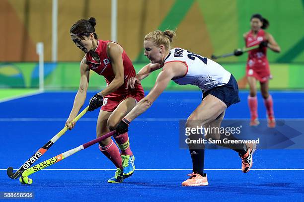Miyuki Nakagawa of Japan is defended by Nicola White of Great Britain during a Women's Preliminary Pool B match at the Olympic Hockey Centre on...