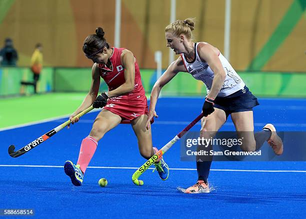 Miyuki Nakagawa of Japan is defended by Nicola White of Great Britain during a Women's Preliminary Pool B match at the Olympic Hockey Centre on...