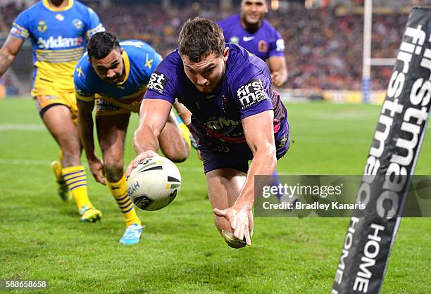 Corey Oates of the Broncos dives over to score a try during the round 23 NRL match between the Brisbane Broncos and the Parramatta Eels at Suncorp...